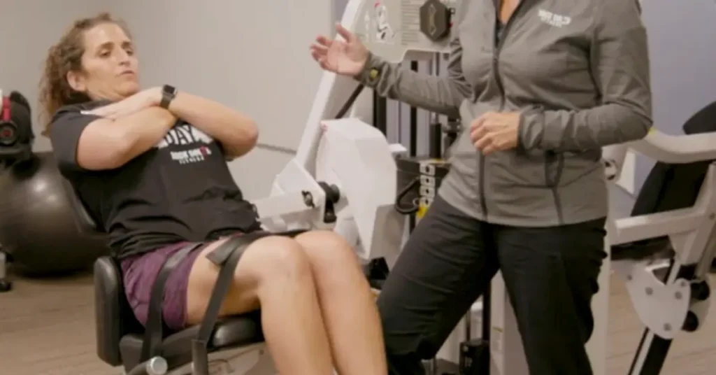 Client Working Out Lower Back Muscles on Nautilus Nitro Low Back Machine