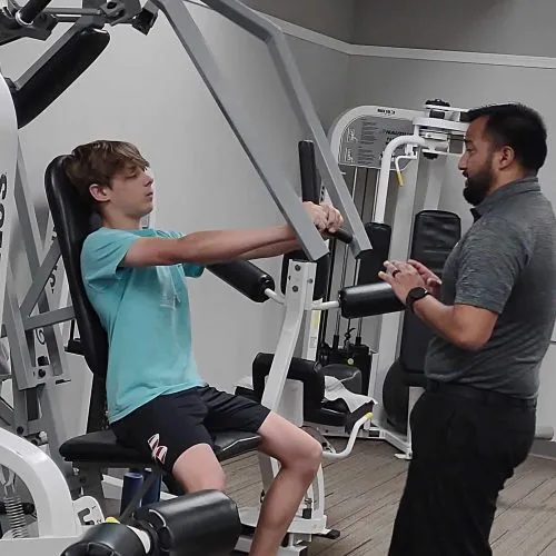 Youth Athlete Working Out On Chest Press